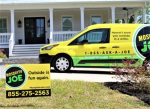Mosquito Joe yard sign and service van placed in front of a Stamford, CT residence